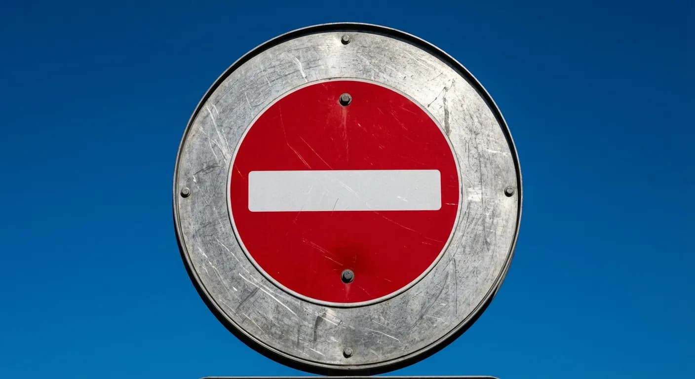 Senso vietato: sanzioni e Codice della Strada 2024 Panneau de signalisation sens interdit minimaliste sur fond de ciel bleu.